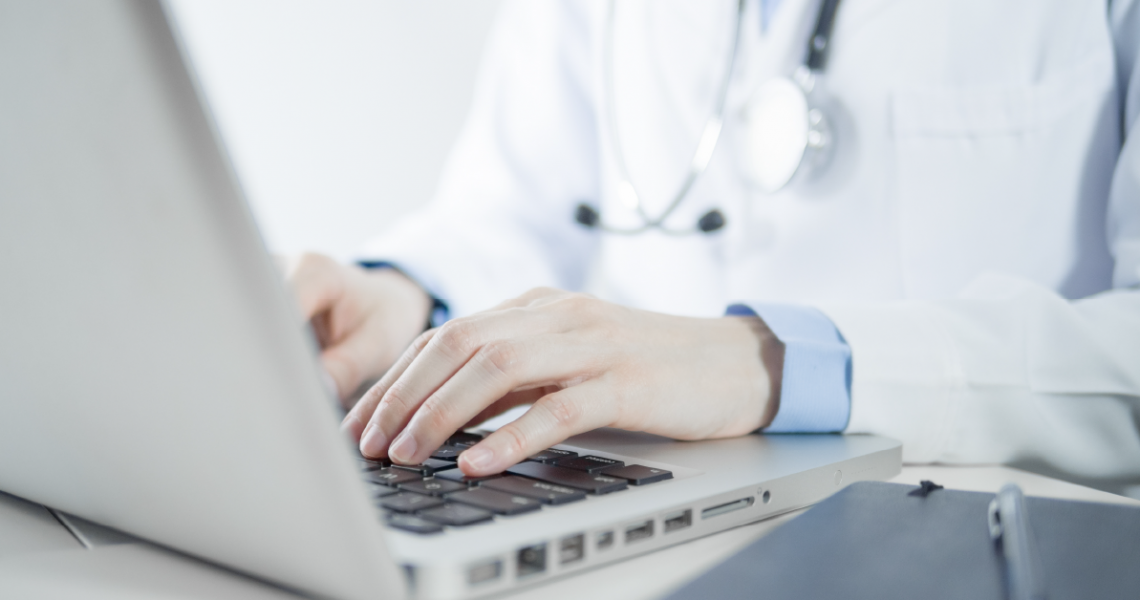 Clinician on a computer dealing with complex EHR workflows